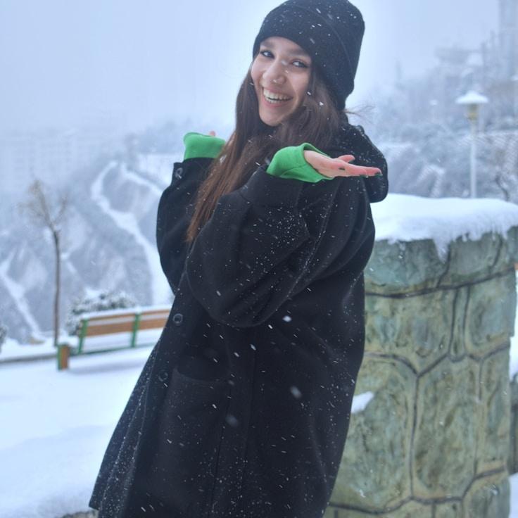 Ava Singh, Lead Design Curator at MoonlitGardenCommunity, reviewing corporate floral arrangements